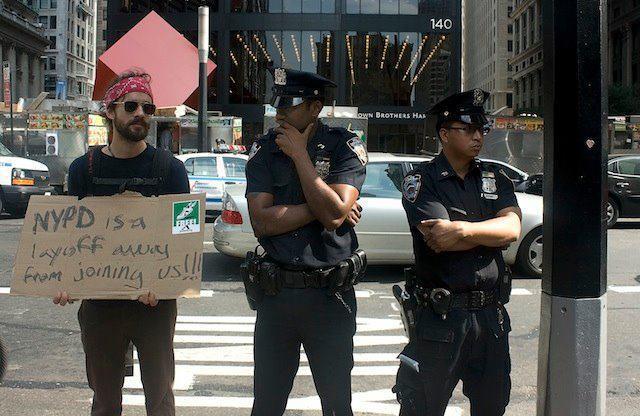 Protest sign-cops layoff away