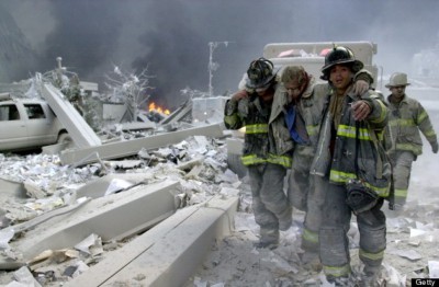 UNITED STATES - SEPTEMBER 11:  Firefighters Todd Heaney and Frankie DiLeo, of Engine 209, carry injured firefighter from the rubble of the World Trade Center.,  (Photo by Todd Maisel/NY Daily News Archive via Getty Images)