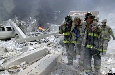 UNITED STATES - SEPTEMBER 11: Firefighters Todd Heaney and Frankie DiLeo, of Engine 209, carry injured firefighter from the rubble of the World Trade Center., (Photo by Todd Maisel/NY Daily News Archive via Getty Images)